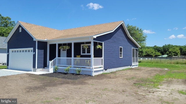 view of front of home with covered porch and a garage