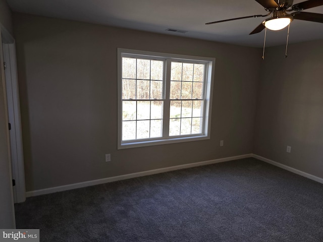 carpeted spare room featuring ceiling fan