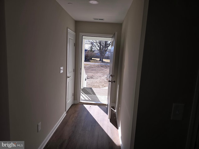 doorway to outside featuring dark wood-type flooring