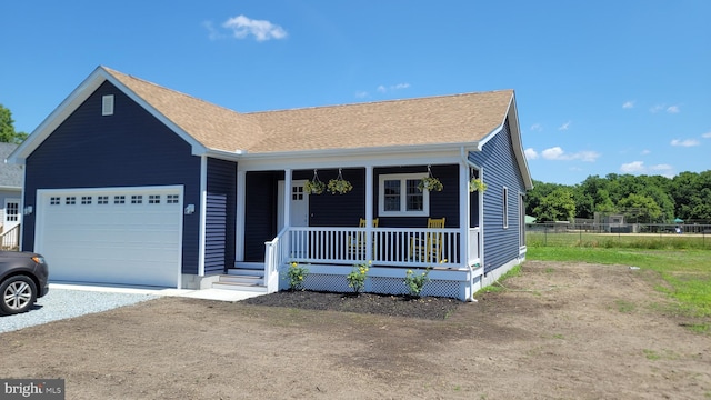 view of front facade featuring covered porch and a garage