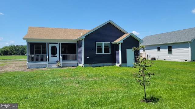 view of front of home with a sunroom and a front lawn