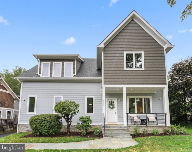 view of front facade with covered porch and a front lawn