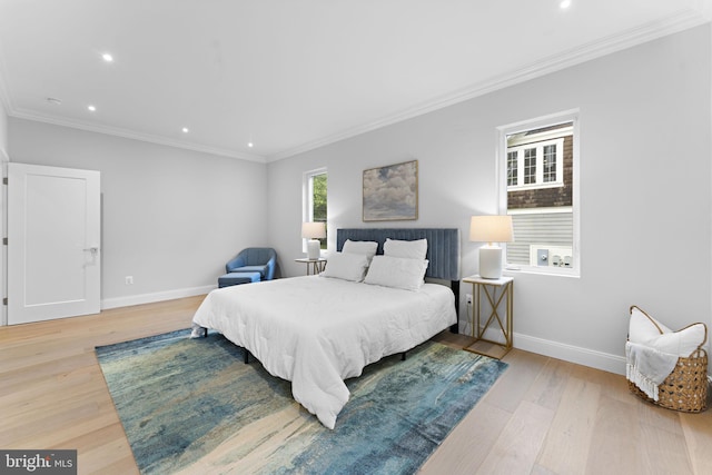 bedroom featuring crown molding and light wood-type flooring