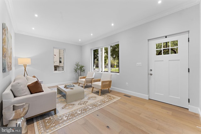 living room with crown molding and light hardwood / wood-style flooring