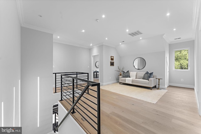 interior space featuring light hardwood / wood-style floors and crown molding