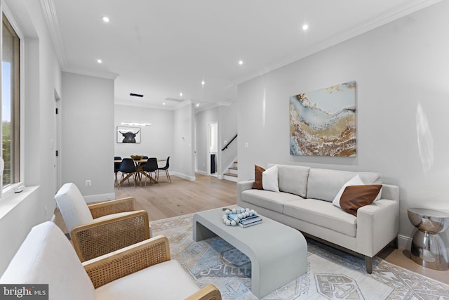 living room with ornamental molding and light wood-type flooring