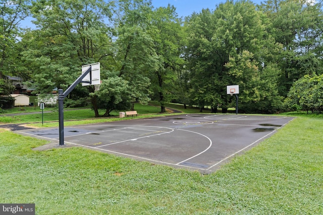 view of sport court featuring a lawn