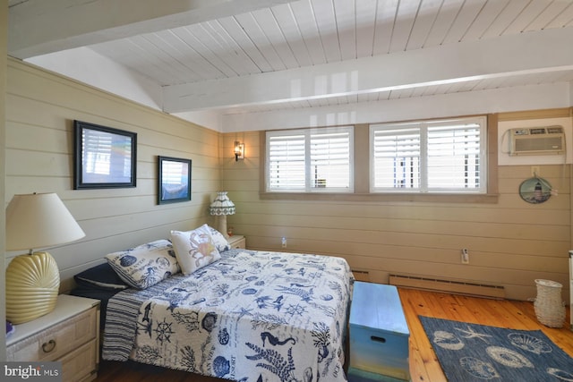 bedroom featuring multiple windows, beamed ceiling, a baseboard radiator, and dark wood finished floors