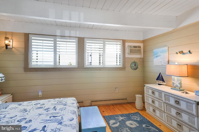 bedroom featuring a baseboard heating unit, beam ceiling, a wall mounted air conditioner, and multiple windows