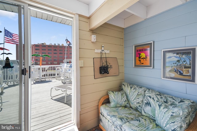 doorway to outside featuring wooden walls