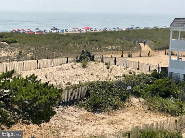 view of yard featuring a water view and fence