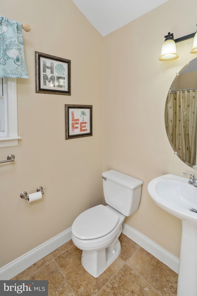 bathroom featuring tile patterned floors and toilet