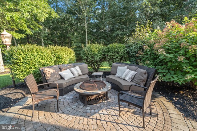 view of patio / terrace with an outdoor living space with a fire pit