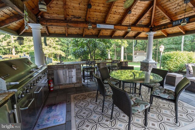 view of patio / terrace featuring a gazebo, exterior kitchen, and area for grilling