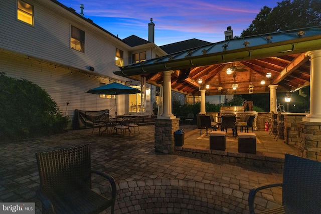 patio terrace at dusk featuring a gazebo