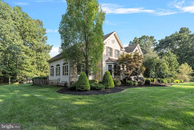 view of property exterior featuring a lawn