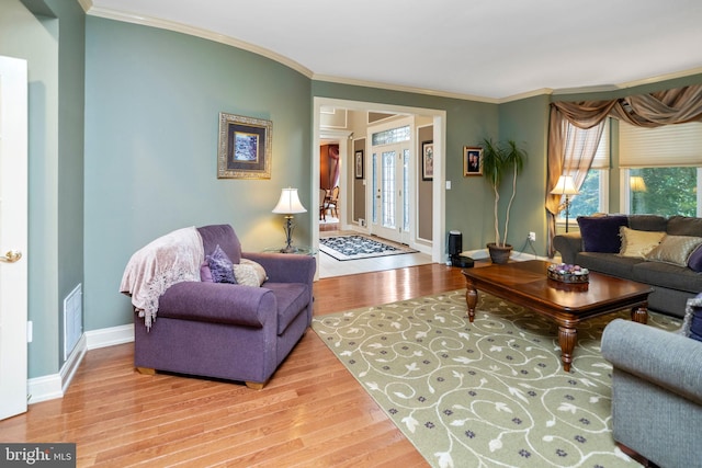 living room featuring crown molding and hardwood / wood-style floors