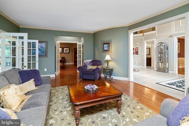 living room with ornamental molding, french doors, and wood-type flooring