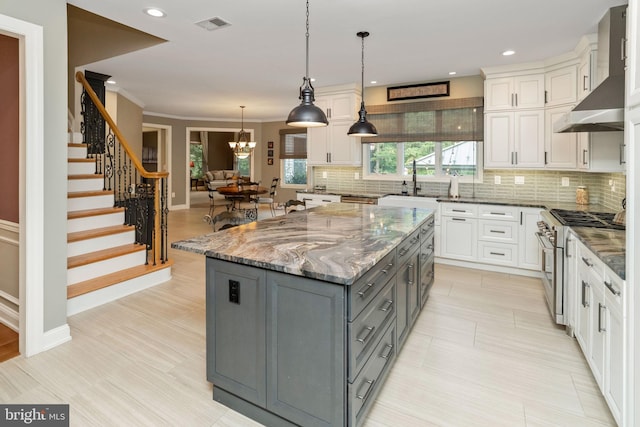 kitchen featuring gray cabinetry, white cabinetry, and appliances with stainless steel finishes