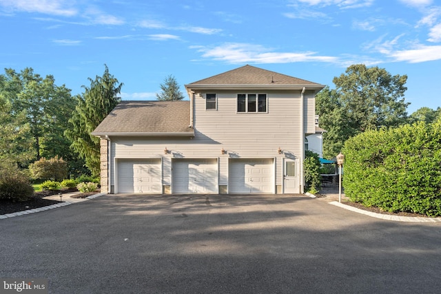 view of side of property with a garage