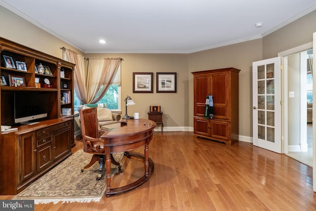 home office with light hardwood / wood-style floors and ornamental molding