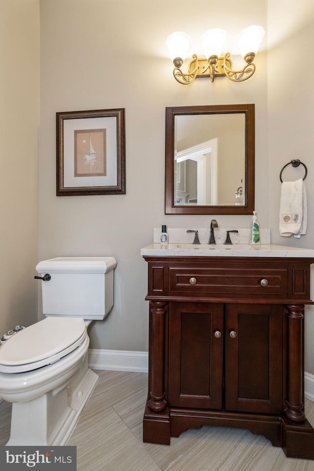 bathroom featuring tile patterned flooring, vanity, and toilet