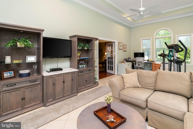 living room with ceiling fan, light tile patterned floors, and ornamental molding