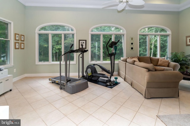 workout room featuring ceiling fan, crown molding, a healthy amount of sunlight, and light tile patterned floors