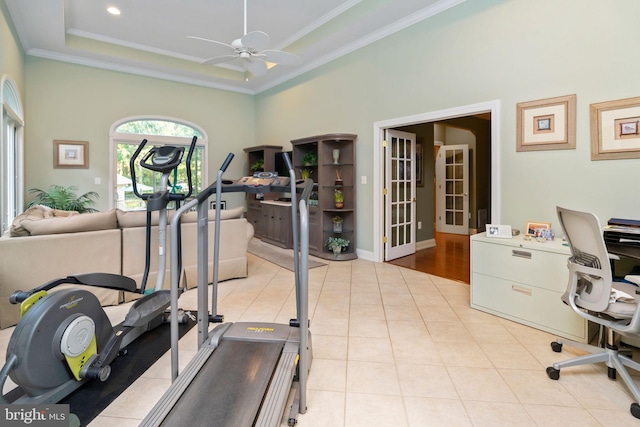 workout room with ceiling fan, light hardwood / wood-style floors, and crown molding