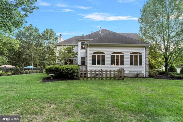 rear view of house with a lawn