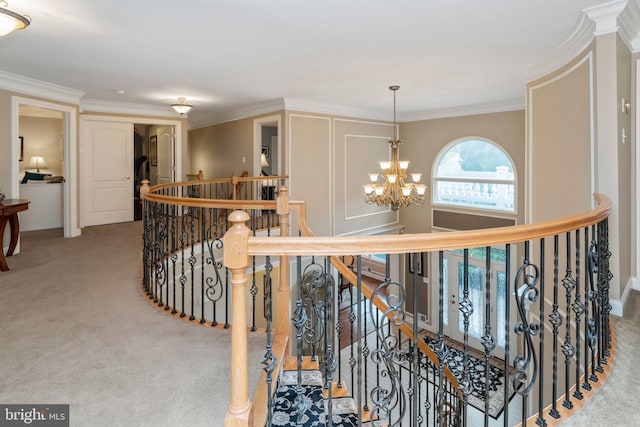 hall with crown molding, light colored carpet, and a chandelier