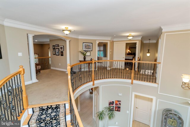 carpeted dining area with crown molding and decorative columns