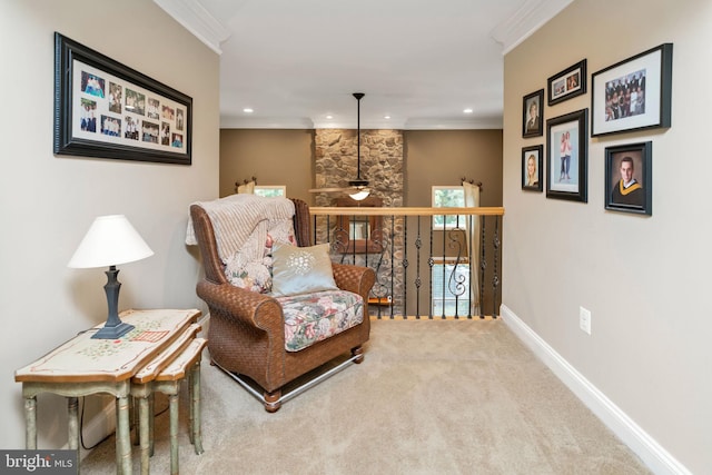 sitting room featuring ceiling fan, crown molding, and carpet flooring