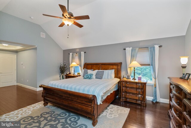 bedroom with ceiling fan, vaulted ceiling, and dark wood-type flooring