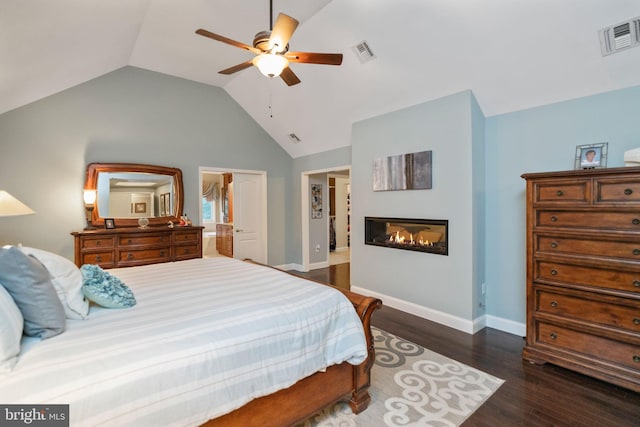 bedroom featuring ceiling fan, dark wood-type flooring, and lofted ceiling