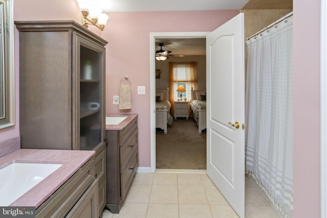 bathroom featuring ceiling fan with notable chandelier, tile patterned flooring, and vanity