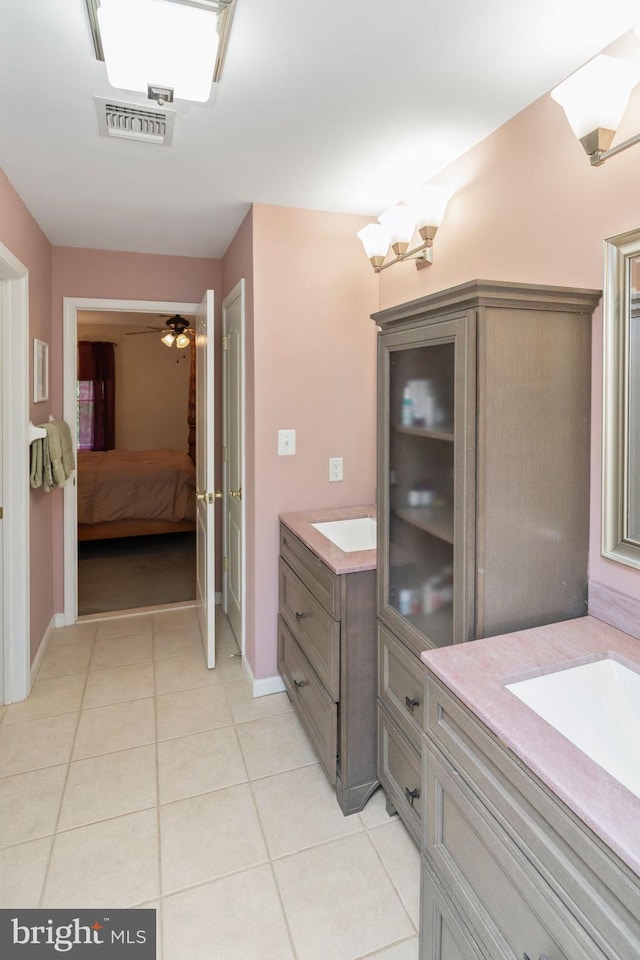 bathroom with tile patterned flooring, ceiling fan, and vanity