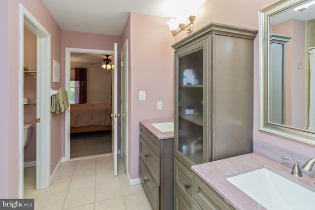 bathroom with ceiling fan, toilet, tile patterned flooring, and vanity