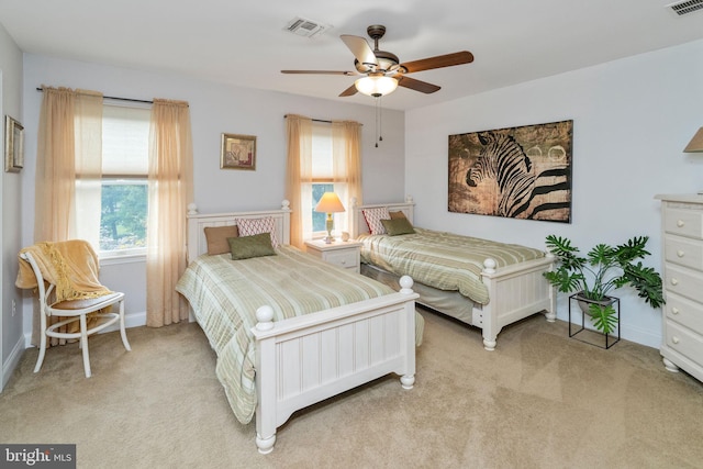 bedroom featuring ceiling fan and light carpet