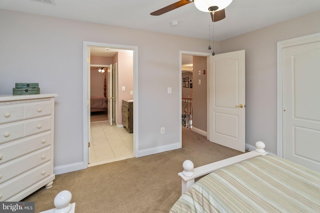 tiled bedroom featuring ceiling fan and ensuite bath