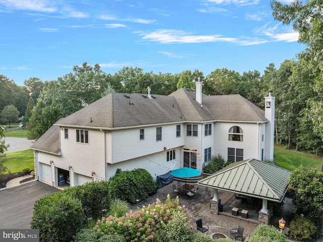 rear view of house with a garage