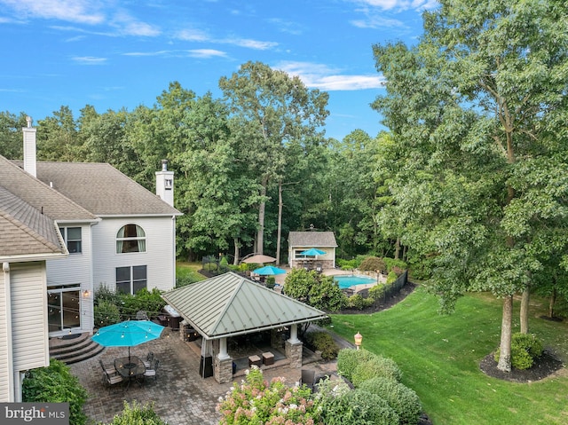 view of yard with an outbuilding and a patio area