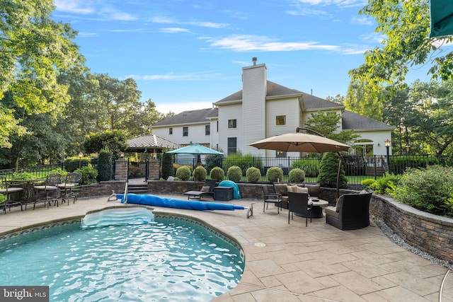 view of pool with a patio area and a gazebo