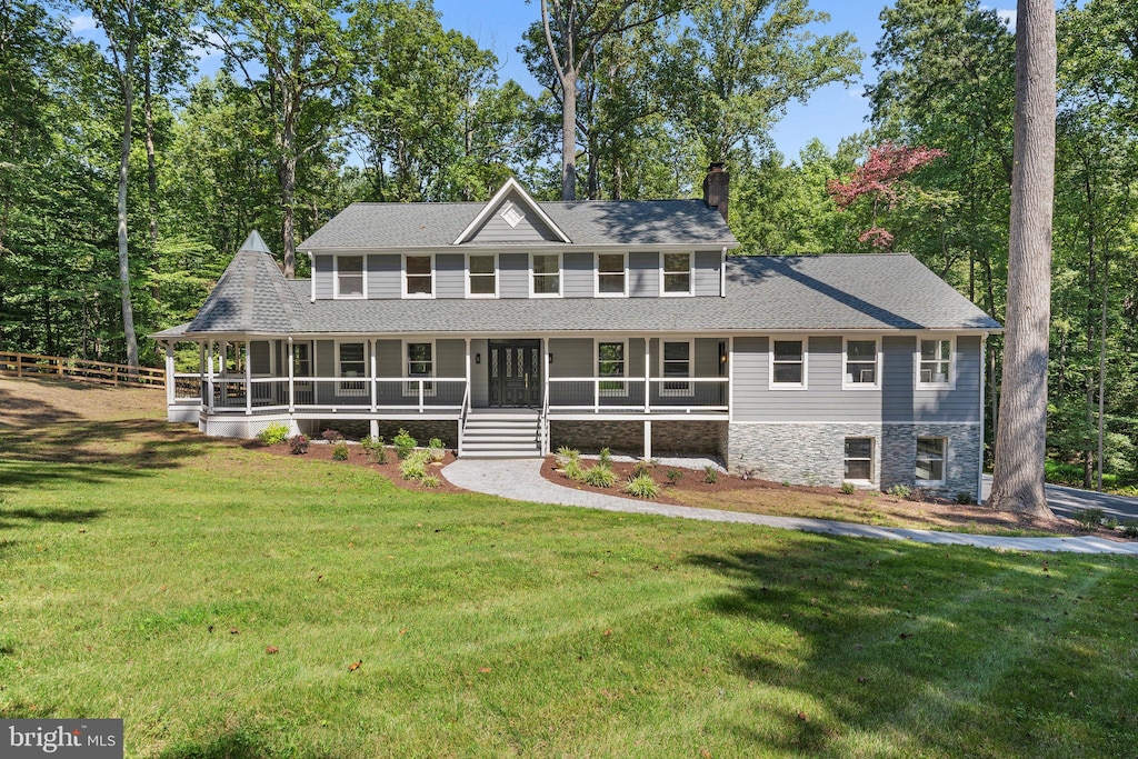 view of front facade featuring a front yard and a sunroom