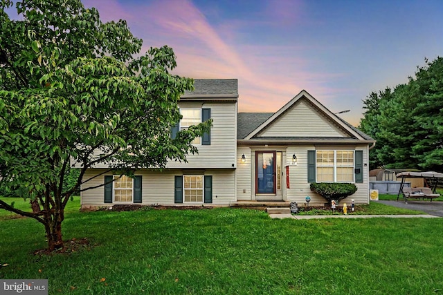 tri-level home featuring a lawn