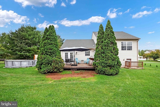 back of property featuring a swimming pool side deck and a yard