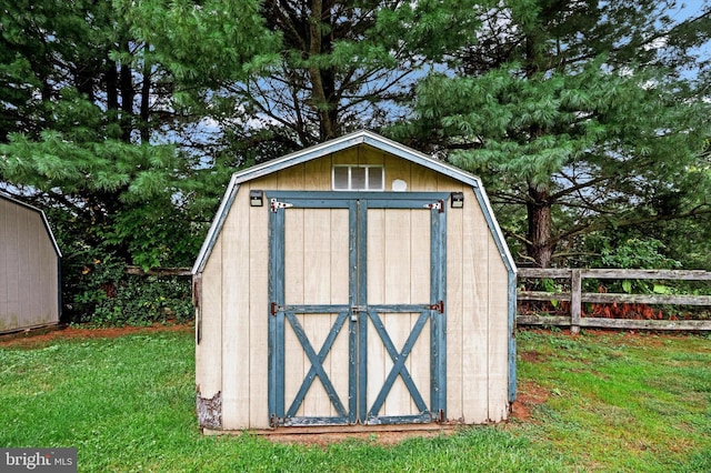 view of outbuilding with a yard