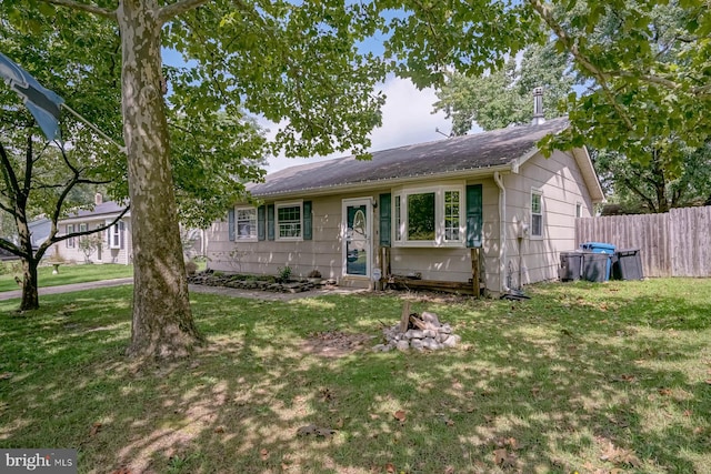 ranch-style home featuring a front yard