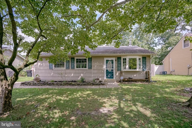 ranch-style house with a front lawn and central AC unit