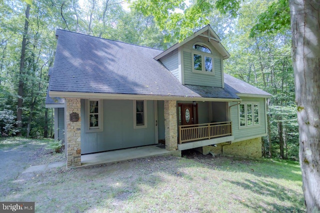 view of front of property featuring covered porch and a shingled roof